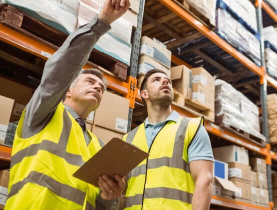 Warehouse workers handling packages on a conveyor