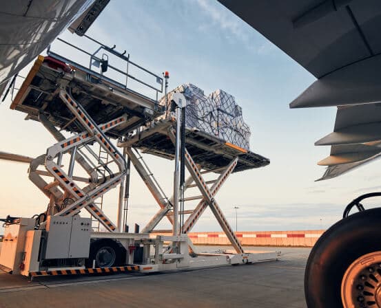 High-loader lifting a cargo pallet to an aircraft's cargo door