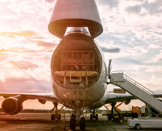 Freighter aircraft with nose cargo door open during loading