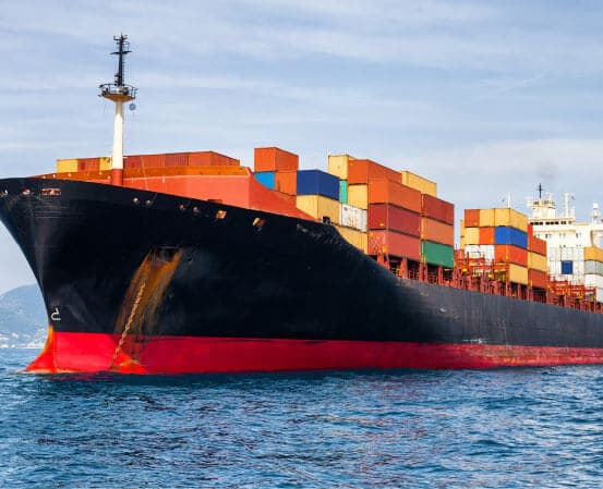 Loaded container ship sailing on open water